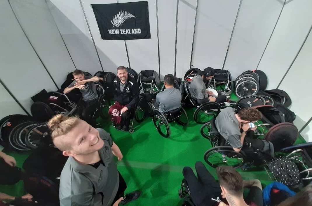 Small room stacked with wheelchairs, equipment and players 