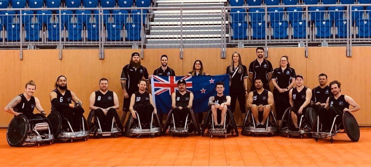 Team photo of the Wheelblacks with New Zealand flag