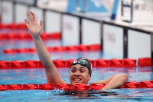 Tupou raises a hand in victory following her race