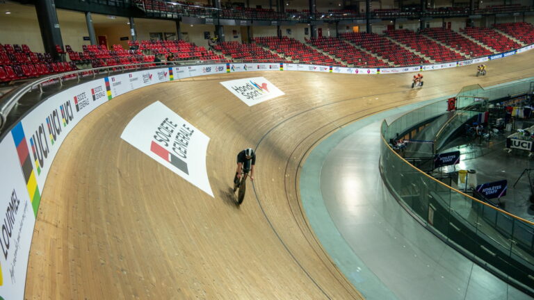 Cyclists training on an indoor velodrome track