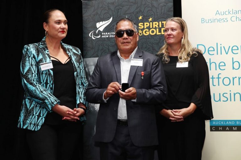 Latoa receives his Paralympic pin with MInister of Disability Issues and PNZ Chief Executive