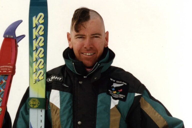 Paralympian Ed Bickerstaff standing with his skis