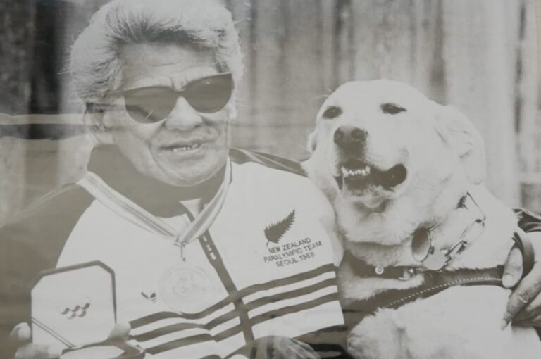 Tui te Rupe in his 1988 Paralympic uniform with his labrador presenting his medal