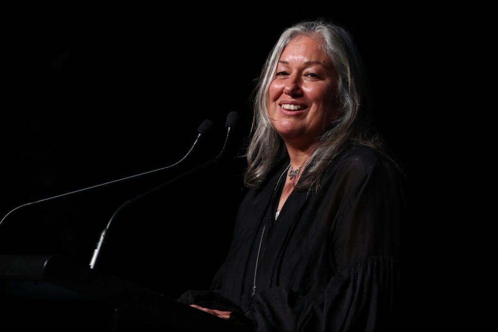Jana Rangooni smiling at a lectern