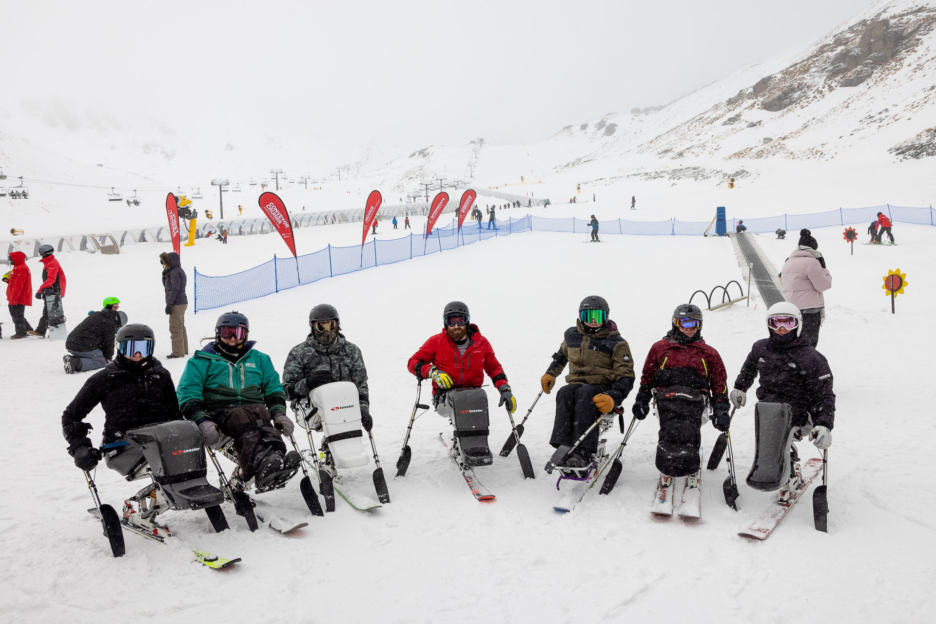 A group of people on sit skis at the Festival