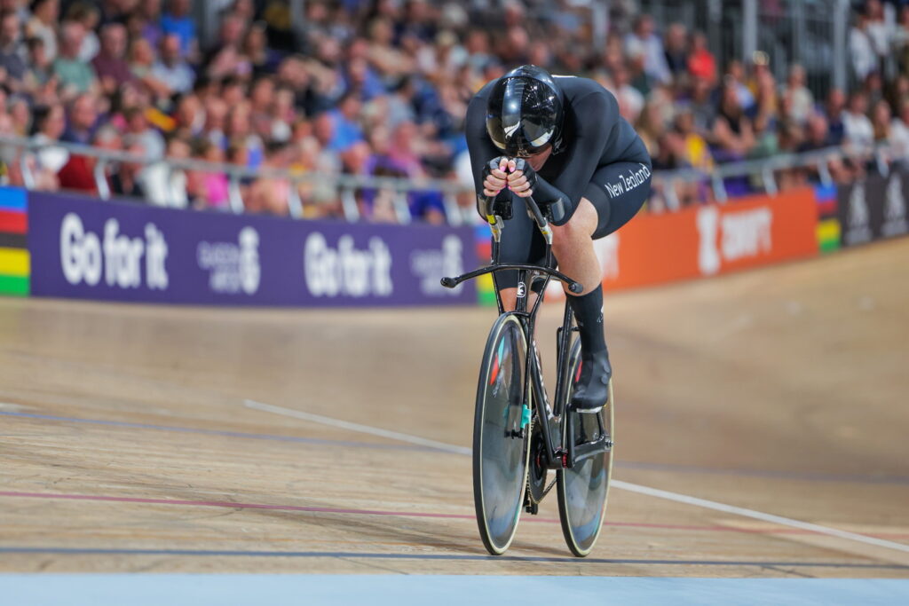 Anna Taylor cycling on a velodrome