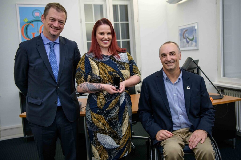 Paralympians Duane Kale and Miriam Sheppard posing with IPC President Andrew Parson after receiving their official pin