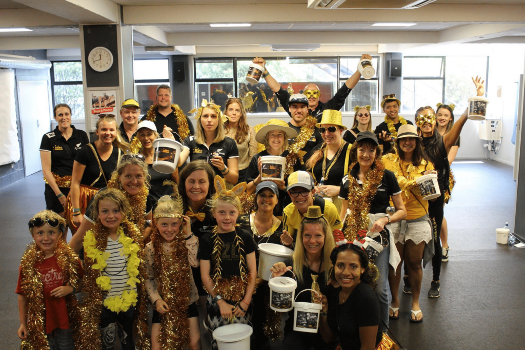 Group of volunteers wearing gold costumes for Paralympics New Zealand
