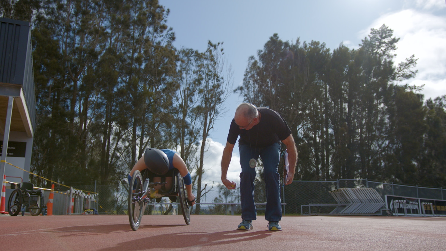 A coach is coaching disabled athletes in Para athletics