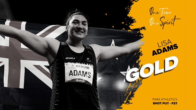 Lisa Adams holding NZ flag after winning Gold