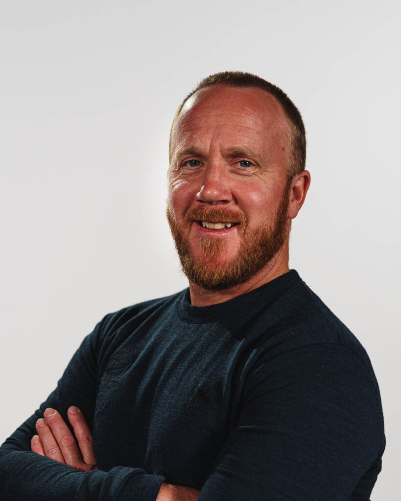 A portrait of Corey Peters on a white background.