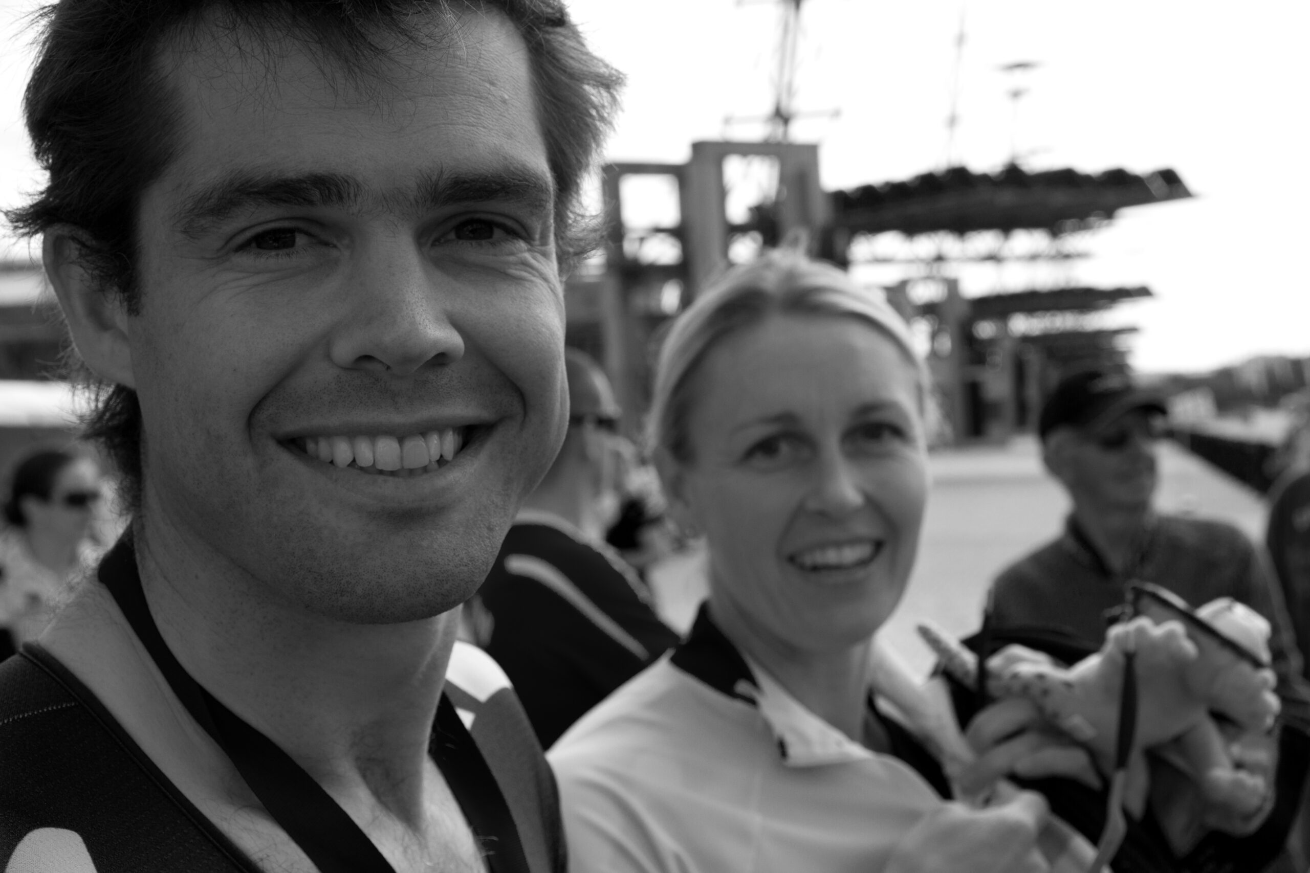 Dark haired man and blond woman smiling in black and white photo
