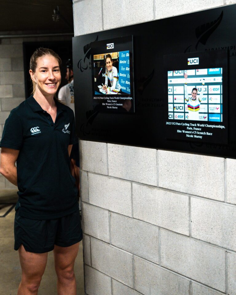 Nicole Murray stands beside her two new plaques