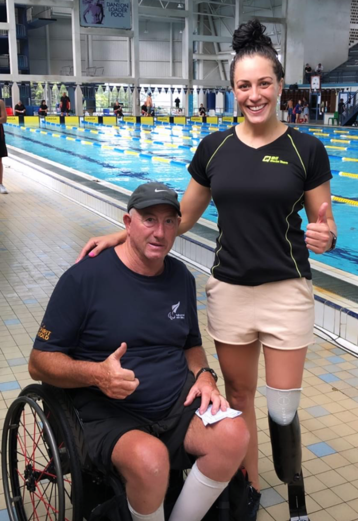 Roly and Sophie giving the thumbs up poolside
