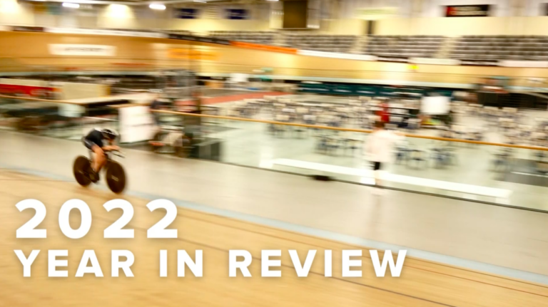 "2022 in review" against backdrop of cyclists in a velodrome