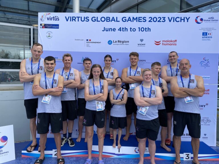 NZ swim team at Virtus Global Games pool with arms folded