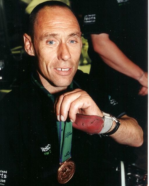 Bill Oughton holds up medal