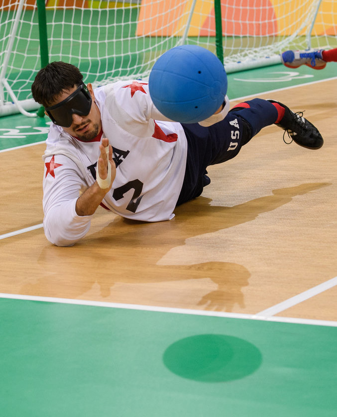 player with blackout mask blocks ball from net