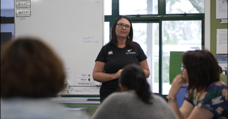 Education Lead, Jenni Keeley, speaking in a classroom. Three people watching