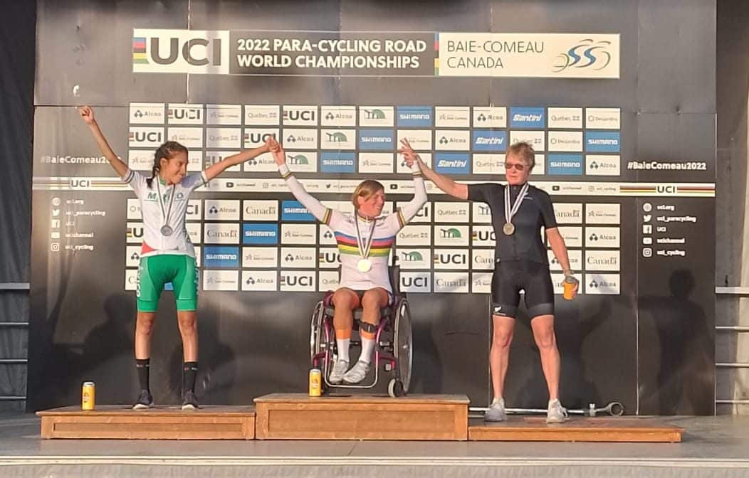 Eltje holds hands with other winners on podium