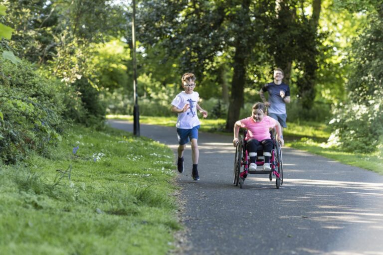 A family run and wheelchair through a park