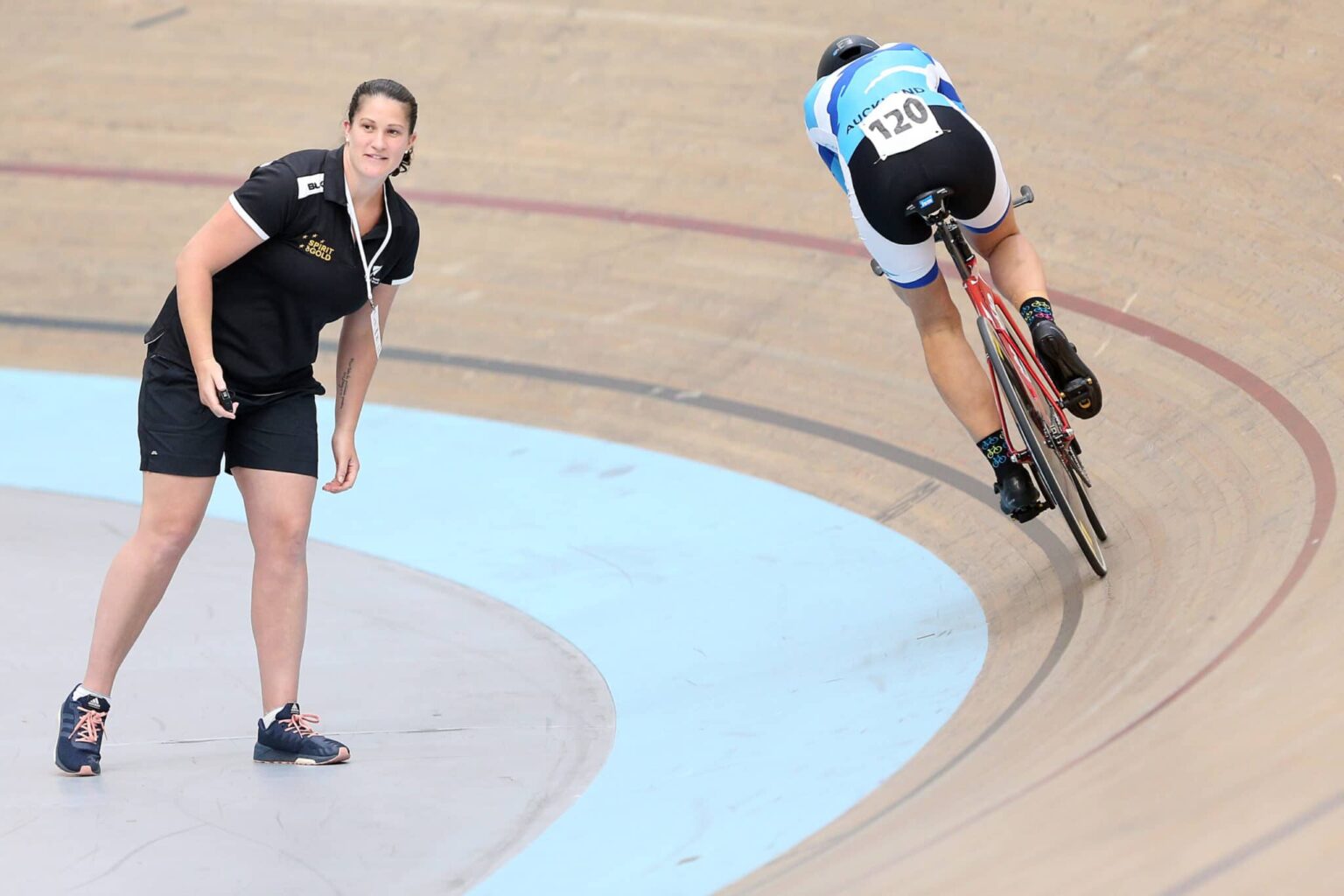 Laura Thomspon cycling coach with cyclist on the track