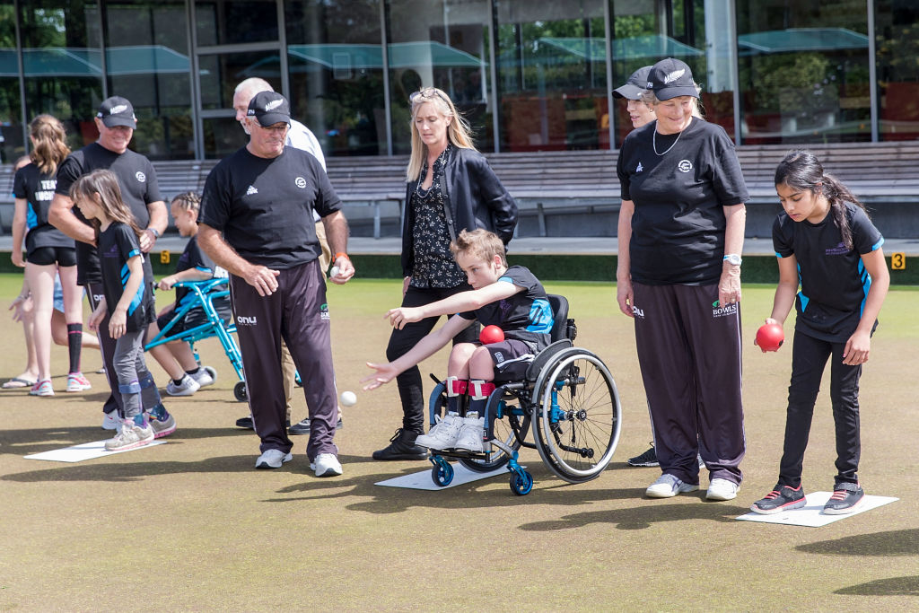 Para junior athletes having a go at lawn bowls supervised by Peter Blick during the New Zealand Commonwealth Games Para Lawn Bowls & Athletics Team Announcements at Carlton Cornwall Bowls Club on November 22, 2017 in Auckland, New Zealand