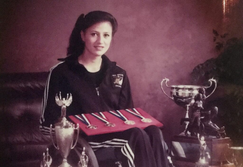 Paralympian number 50 Shelley Kalivati with her 4 Paralympic medals and trophees
