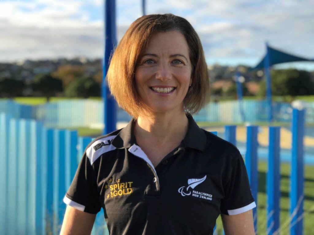 Ruth McLaren with PNZ t-shirt in front of a playground