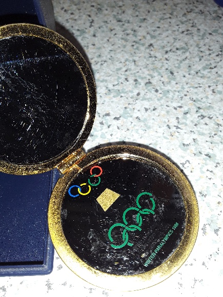 Innsbruck 1988 medal in black showing Olympic rings in green