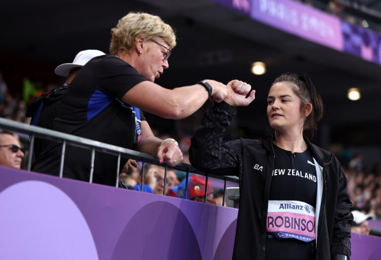 NZ Paralympic Team Chef De Mission Raylene Bates fists bumps Paralympian Holly Robinson at the Women's F46 Javelin at the Paris 2024 Paralympic Games