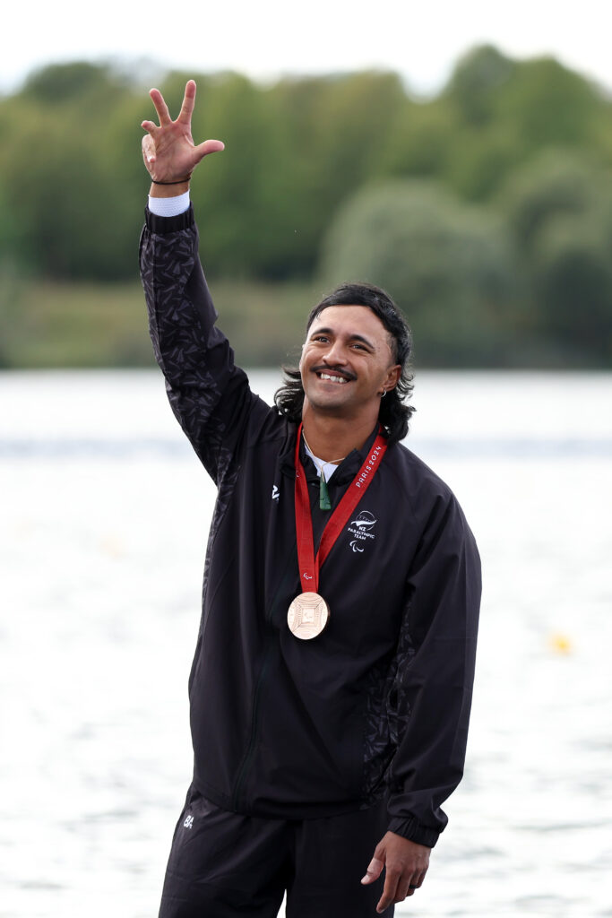 Peter Cowan waves to the crowd as he is presented with a bronze medal in the Men's VL3 200m.