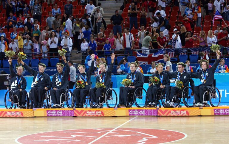 The NZ Wheel Blacks celebrate their gold medals in Wheelchair Basketball at the Athens 2004 Paralympic Games.