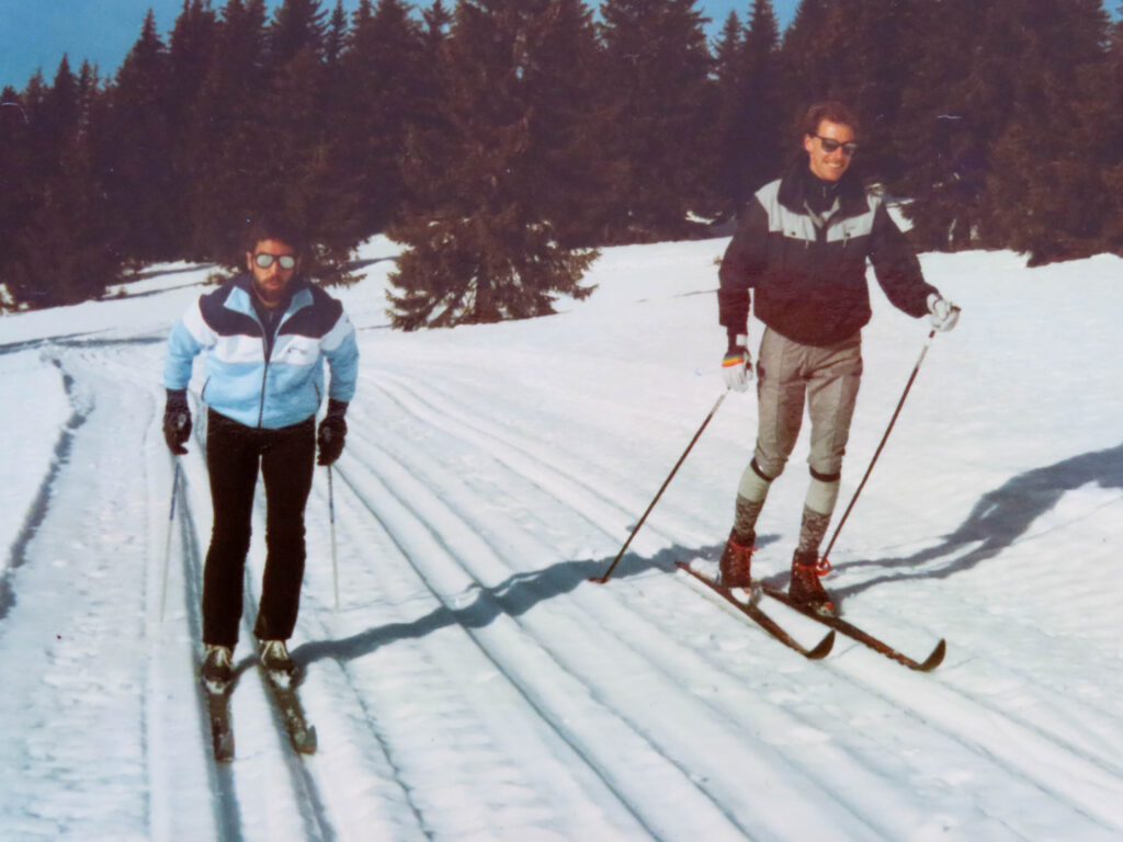 Paralympian #46 Chris Orr (left) skis alongside Team Coach David Boyd at the 1984 Innsbruck Paralympic Games