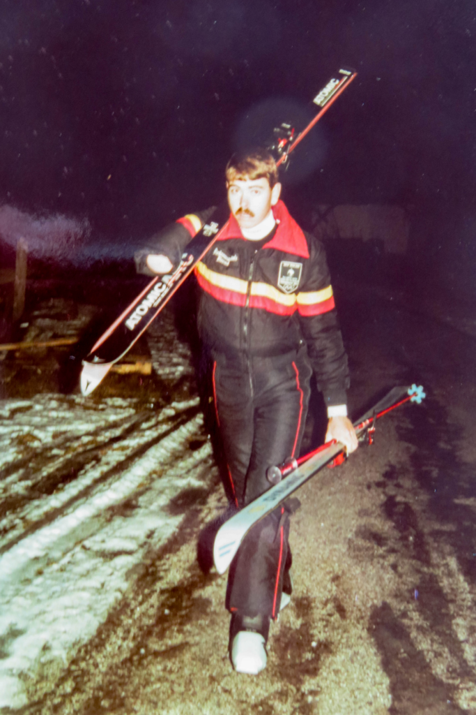 Ed Bickerstaff carries skis at the 1984 Innsbruck Paralympic Games.