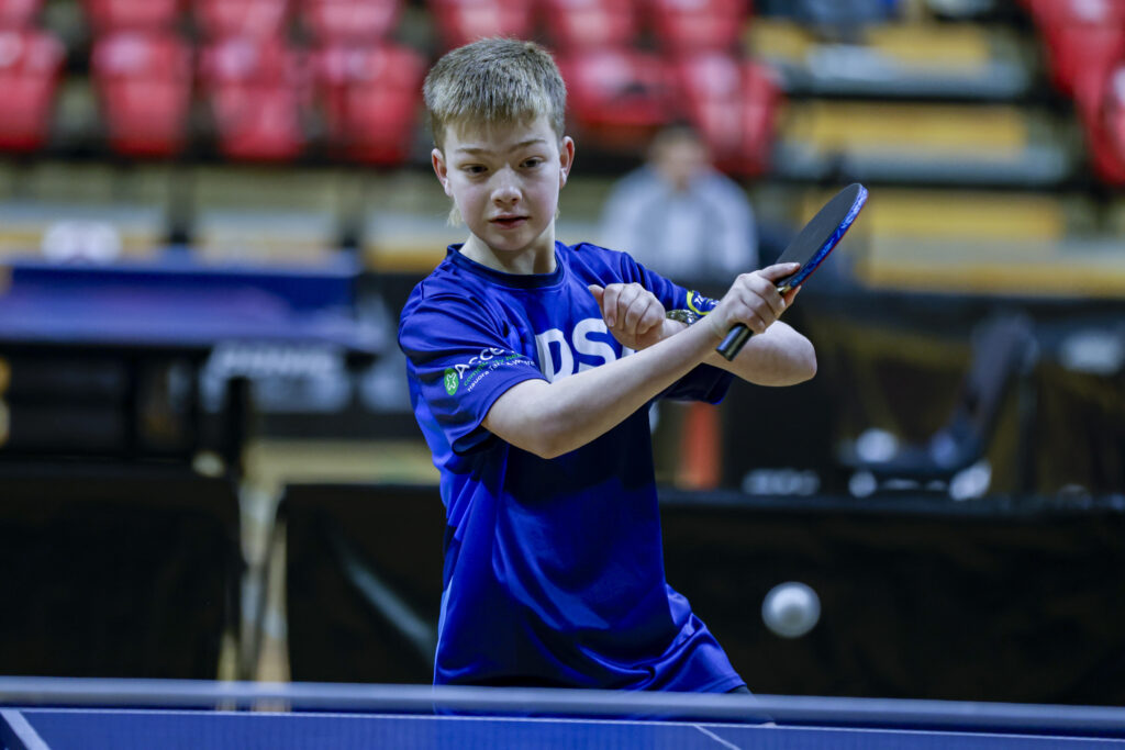 Para Table Tennis player Liam Hogan mid swing in a Table Tennis game