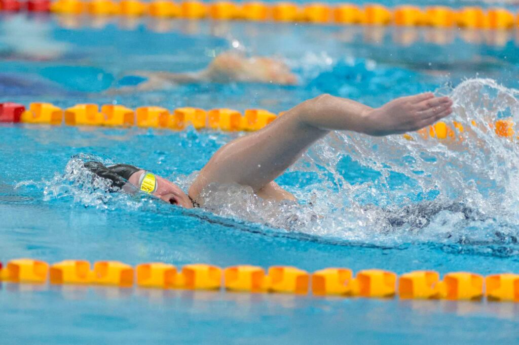 Para swimmer Rylee Sayer mid stroke in the pool.