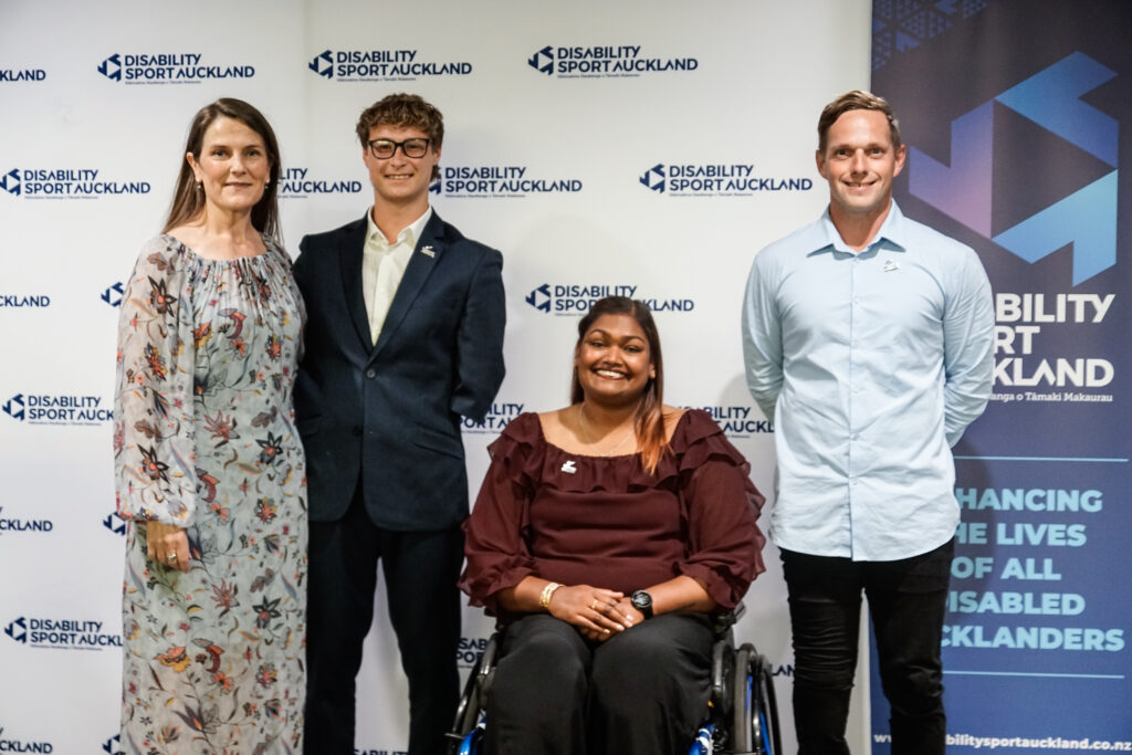 Three Paralympians receive their numbered pin along side Head of Games and Sport Delivery, Lynnette Grace. Left to right stands Lynnette Grace, Joshua Willmer, Neelam O'Neill and Mitchell Joynt