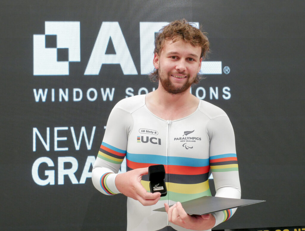 Paralympian #229 Devon Briggs receives his numbered paralympian pin at the Grassroots Trust Velodrome in December 2024.