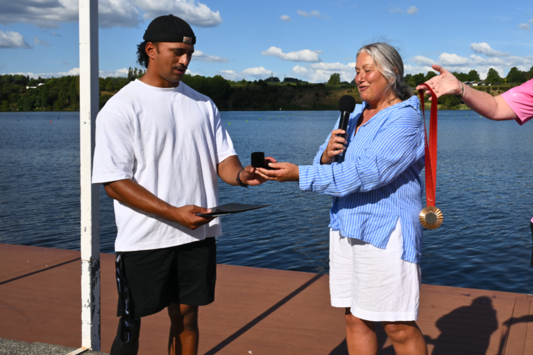 Paralympian #231 Peter Cowan receives his Paralympian Pin from Paralympics NZ Chair Jana Rangooni at the Waka Ama National Sprint Championships at Lake Karapiro, Cambridge.