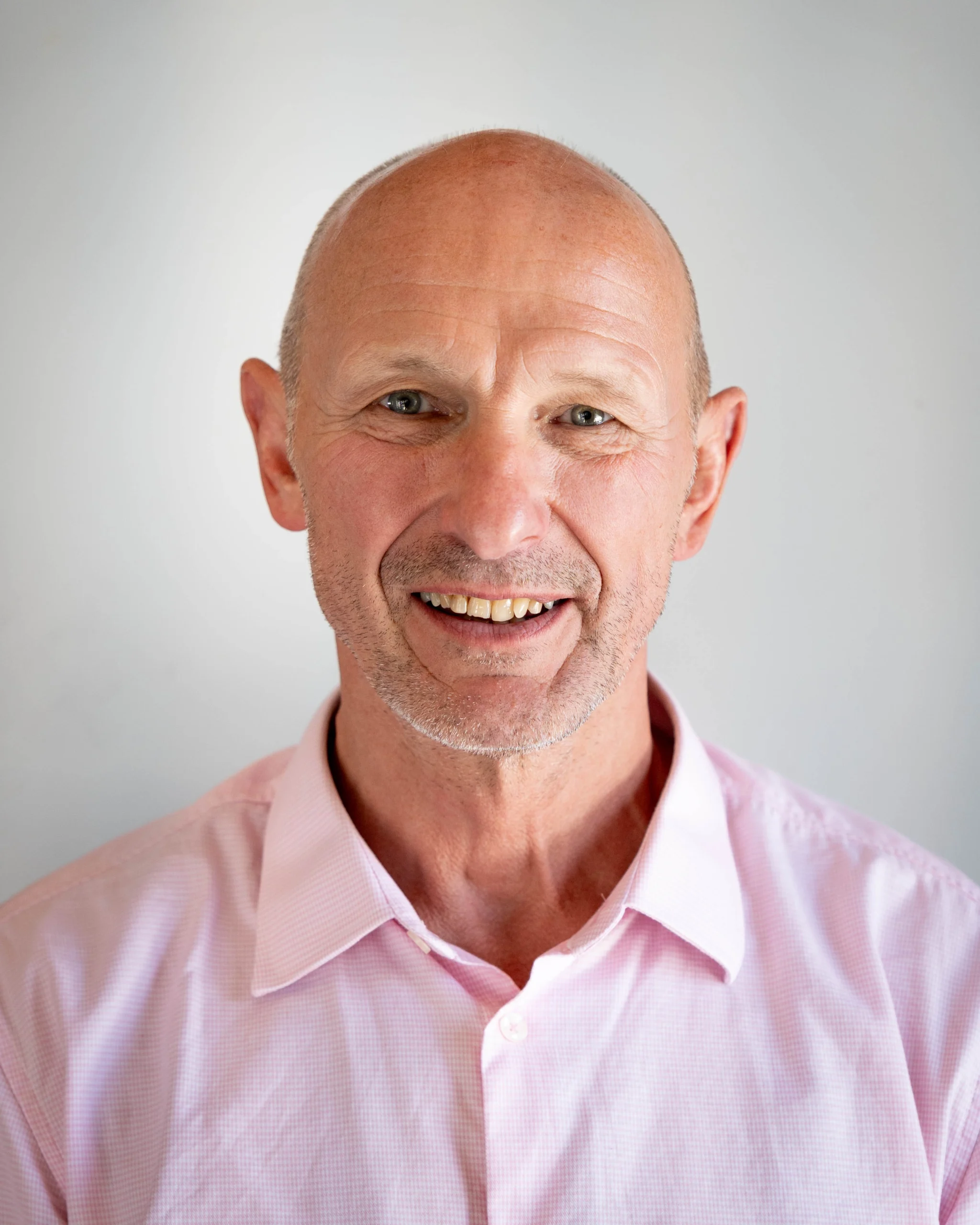 A professional portrait of Graeme Maw on a white background.