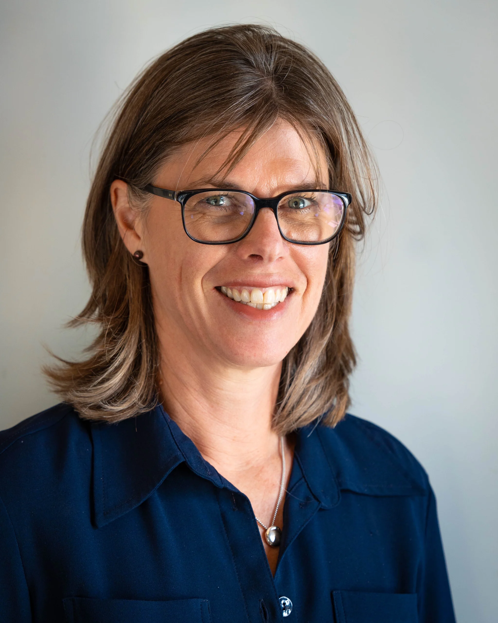 A professional portrait of Maria Clarke on a white background.