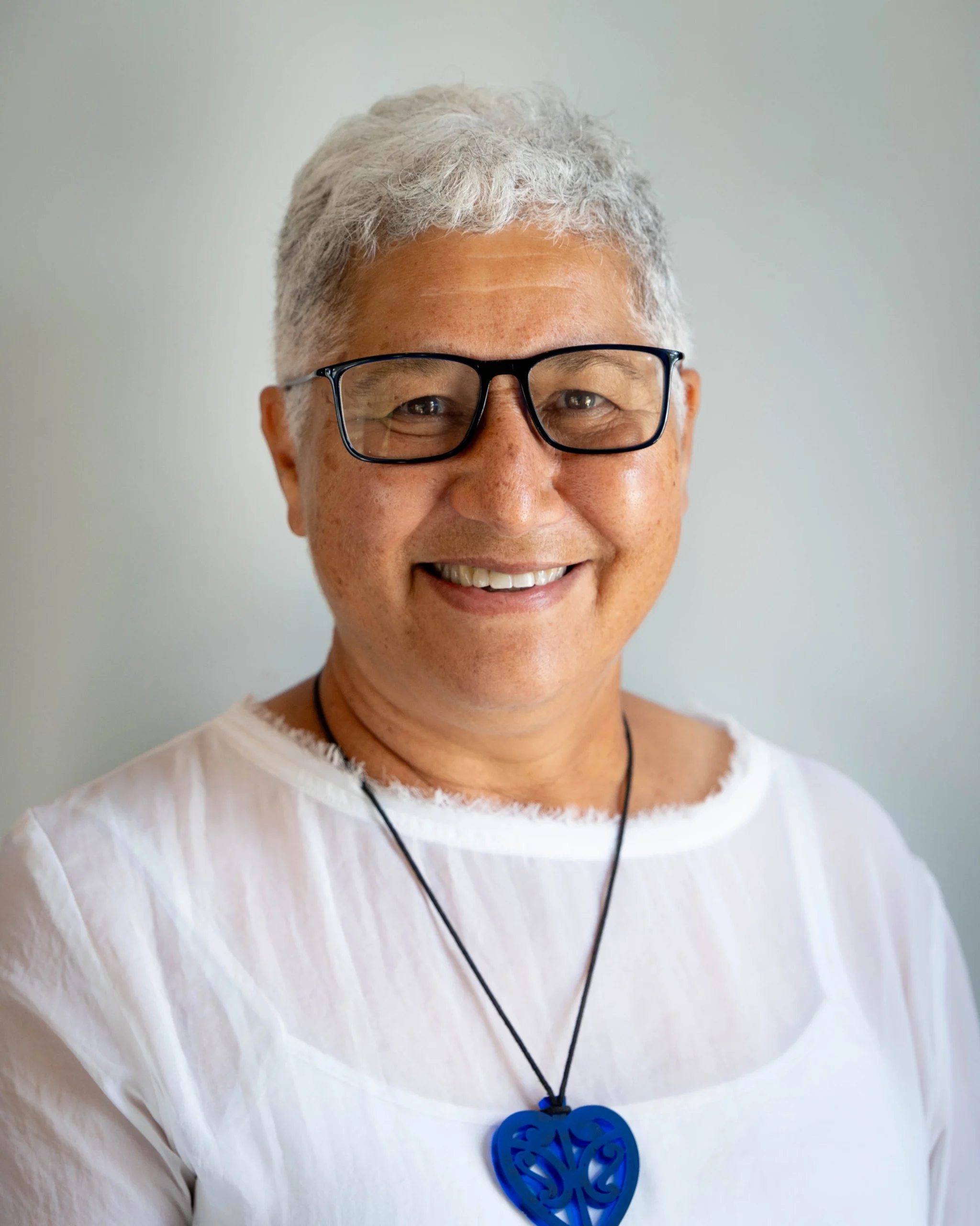 A professional portrait of Pam Elgar on a white background.