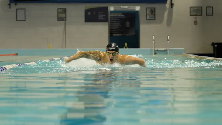 Cameron Leslie emerges from the swimming pool mid stroke.