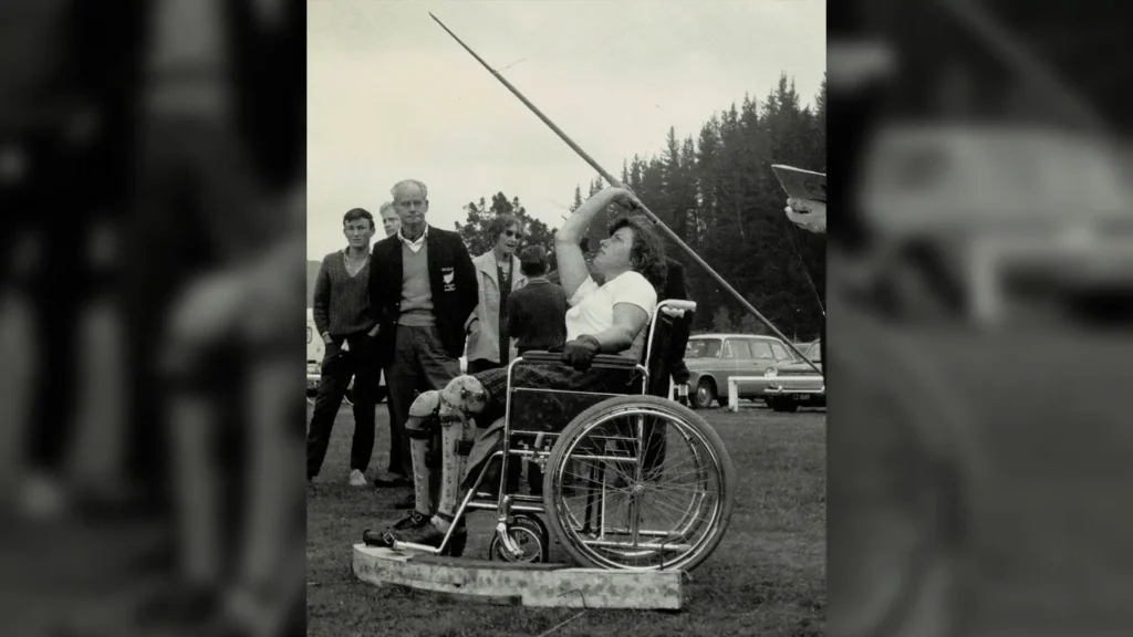 A young Eve Rimmer throws a javelin from her wheelchair.
