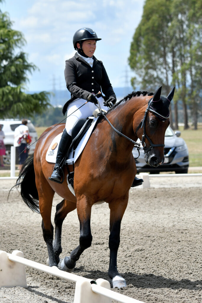 Nicole rides a horse as an adult following her treatment.