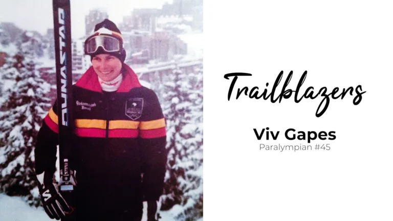 A woman stands on a snow covered mountain holding a pair of skis. Text beside reads "Trailblazers - Viv Gapes"
