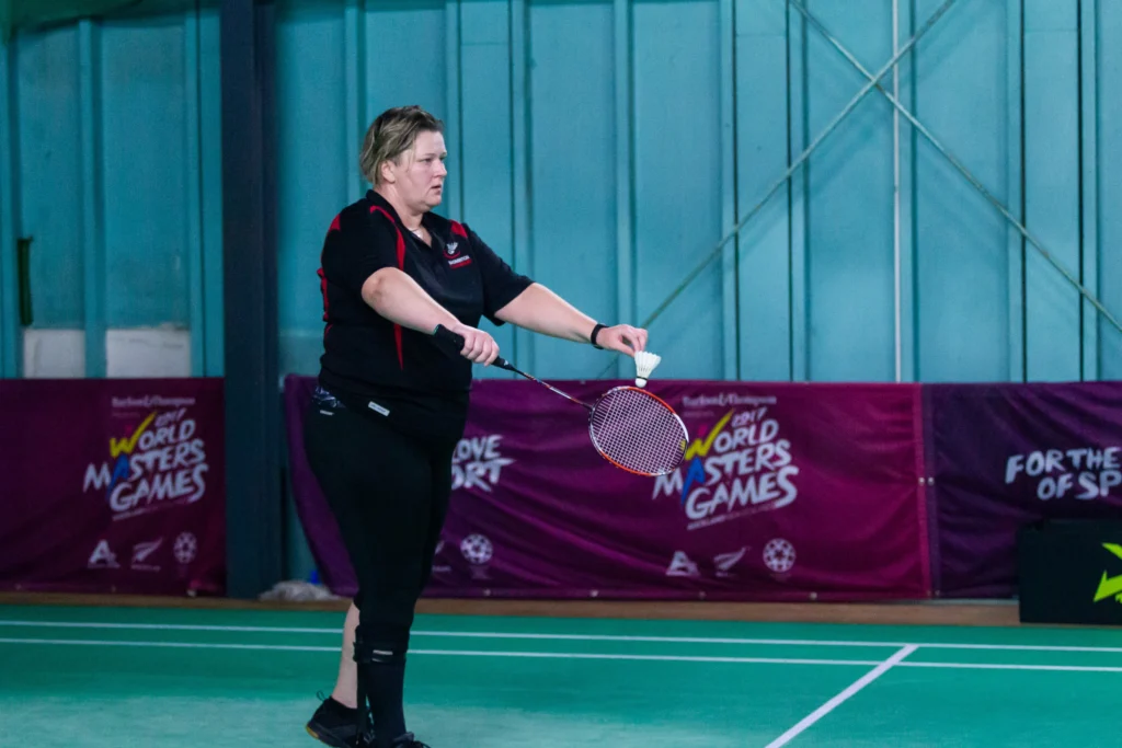 Carrie prepares to serve in a game of Badminton
