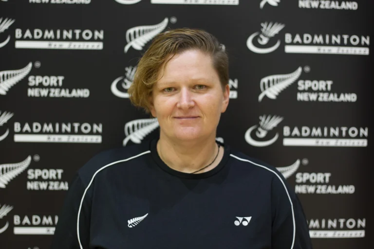 Portrait of Carrie Wilson in front of a Badminton New Zealand banner.