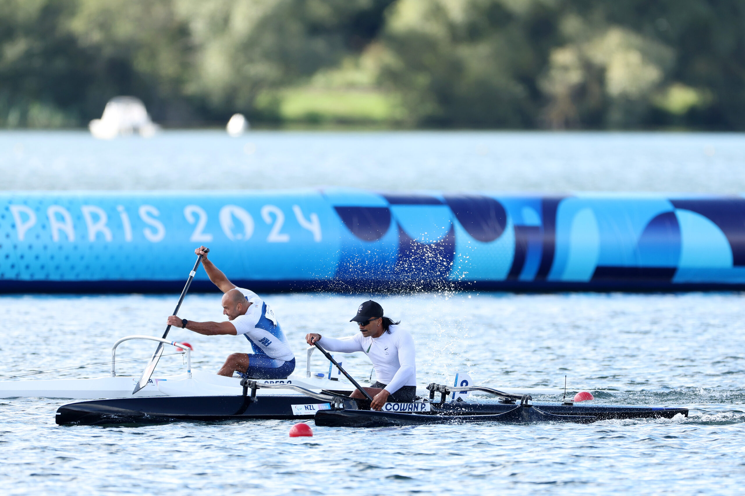 Paralympian #231 paddles in a waka ama canoe at the Paris 2024 Paralympic Games.